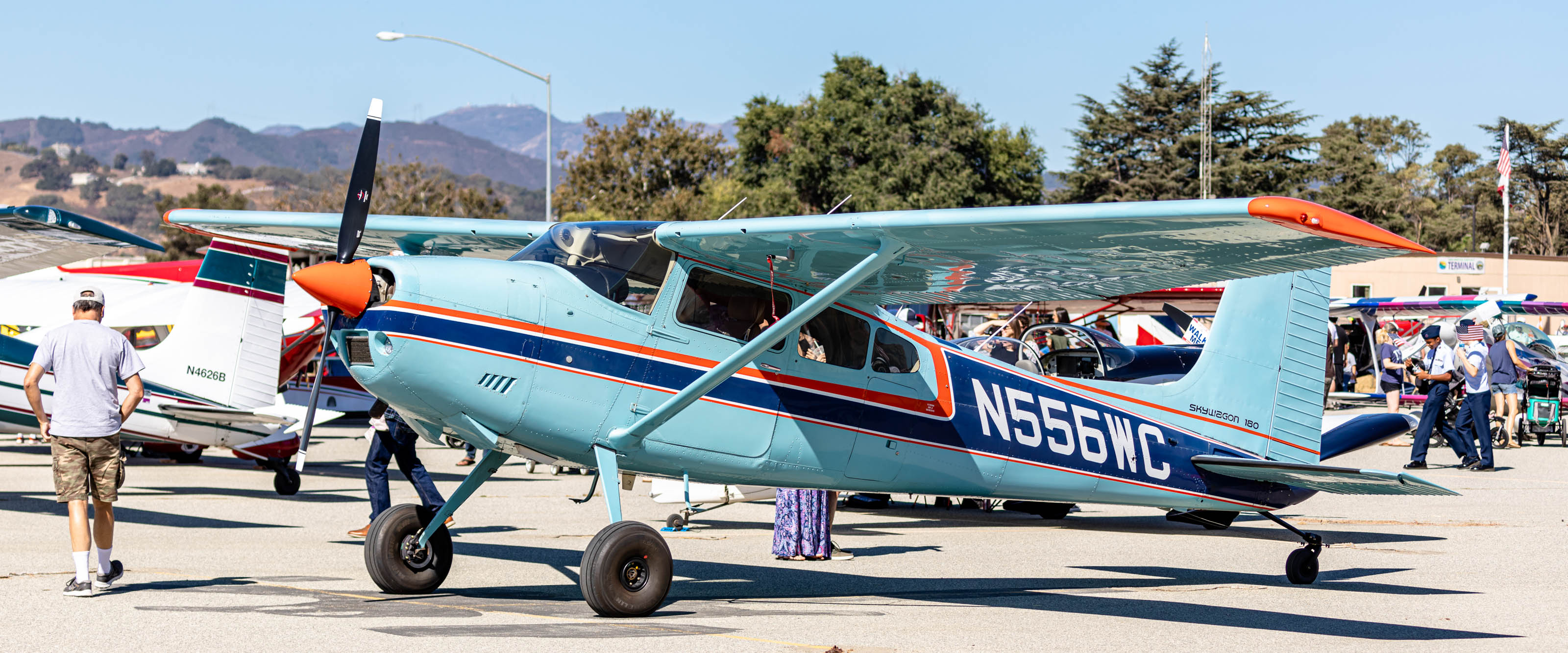 A brightly colored 1975 Cessna 180 graces the flight line at the San Martin Airport's Food Truck Fly-In. Photo by Joshua Lapum Photography.