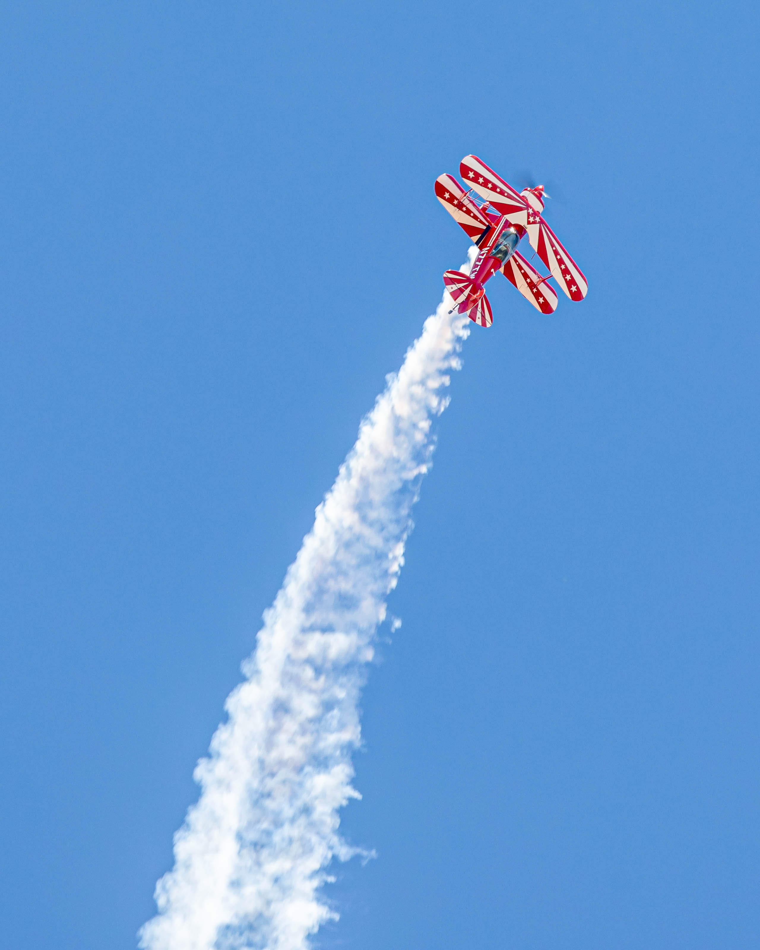 Pilot Dean Hickman-Smith pilots a Christen Industries Inc. Pitts S-2B and gives event attendees a smoke show. Photo by Joshua Lapum Photography.