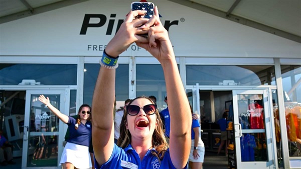 Carly Shukiar documents her fellow Piper Aircraft interns during an eighty-fifth anniversary celebration at EAA AirVenture Oshkosh in Wisconsin July 26. Photo by David Tulis.