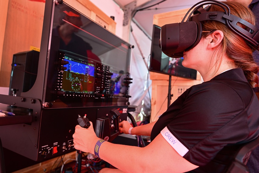 The author tries out a virtual reality simulator at a Redbird Flight Simulations event. Photo by David Tulis.