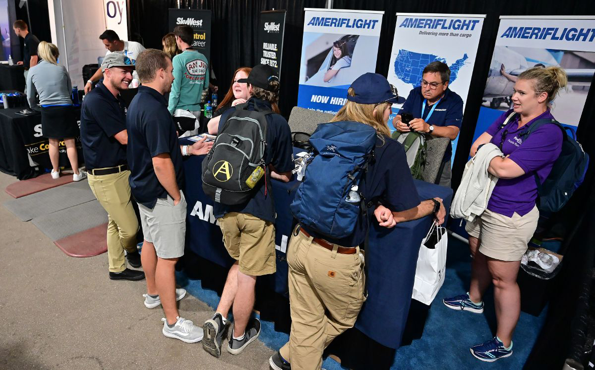 AmeriFlight staff talk with other aviation career specialists in the EAA AirVenture Oshkosh Careers and Education center in 2021. Photo by David Tulis.