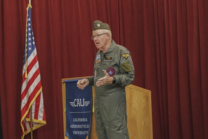 Guest speaker retired U.S. Navy Capt. J. Charles Plumb addresses students and staff at California Aeronautical University’s graduation ceremony. Photo courtesy of California Aeronautical University. 