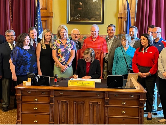 Iowa Gov. Kim Reynolds signs the sales tax exemption for aircraft parts and labor into law on June 14. Photo courtesy of the Iowa Public Airports Association.