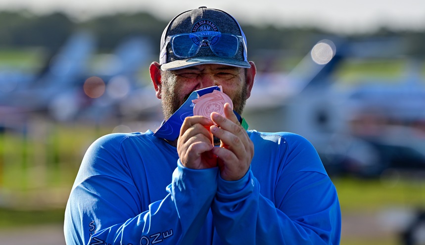 Special Olympian Nathan Boyle of Bethlehem, Pennsylvania, shows a softball medal he won before departing from Orlando Executive Airport. Photo by David Tulis.