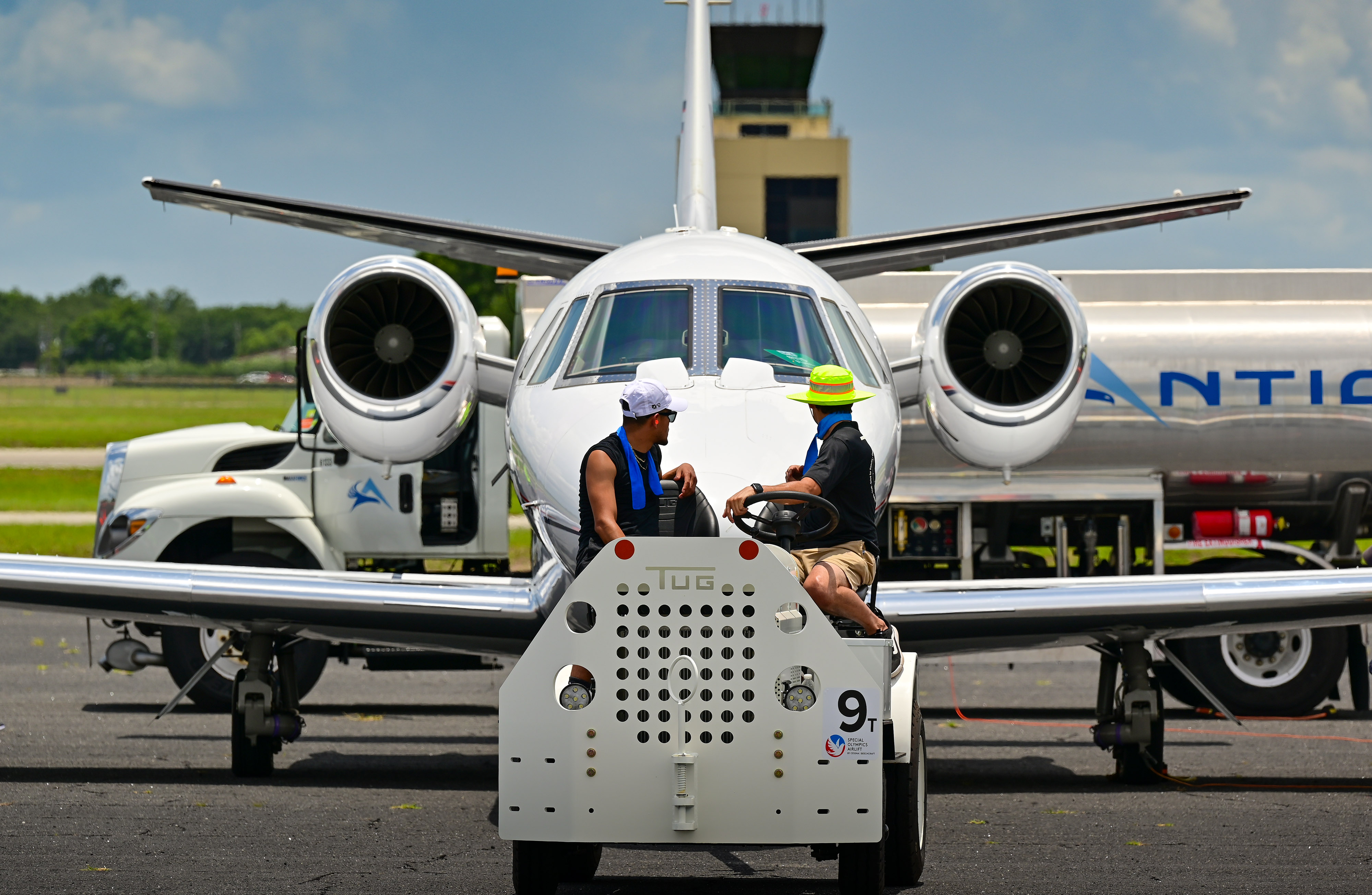 Line personnel at Orlando Executive Airport move a jet during the Textron Aviation-sponsored Special Olympics Airlift transporting Special Olympics USA Games athletes and coaches to and from Orlando, Florida. Photo by David Tulis.