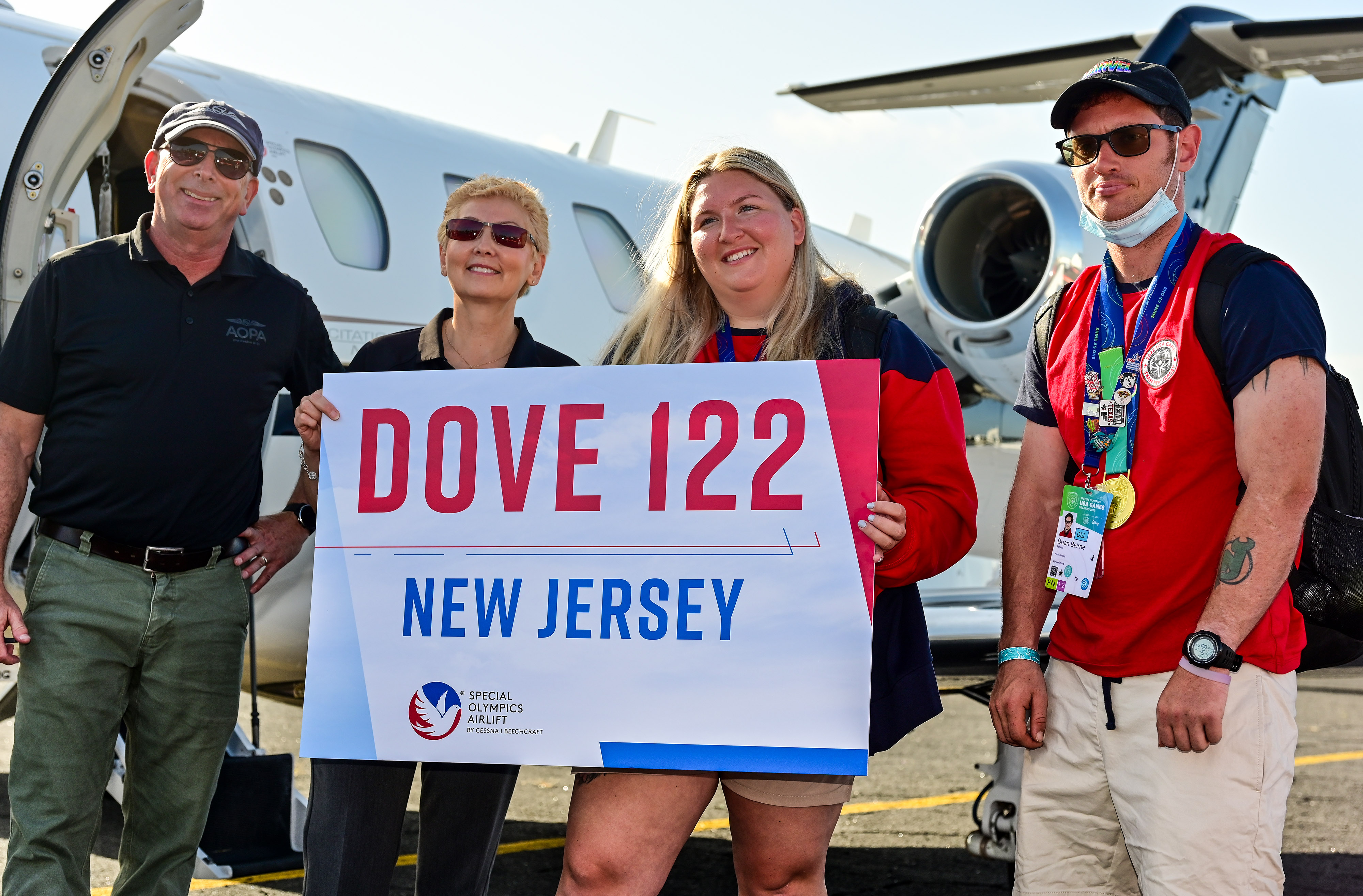 Special Olympics USA Games weightlifter and gold medal winner Brian Beirne, with coach Amanda Bendorf and pilots Luz Beattie and Dave Hirschman, right to left, participate in the Dove 122 flight during the Textron Aviation-sponsored Special Olympics Airlift. Photo by David Tulis.