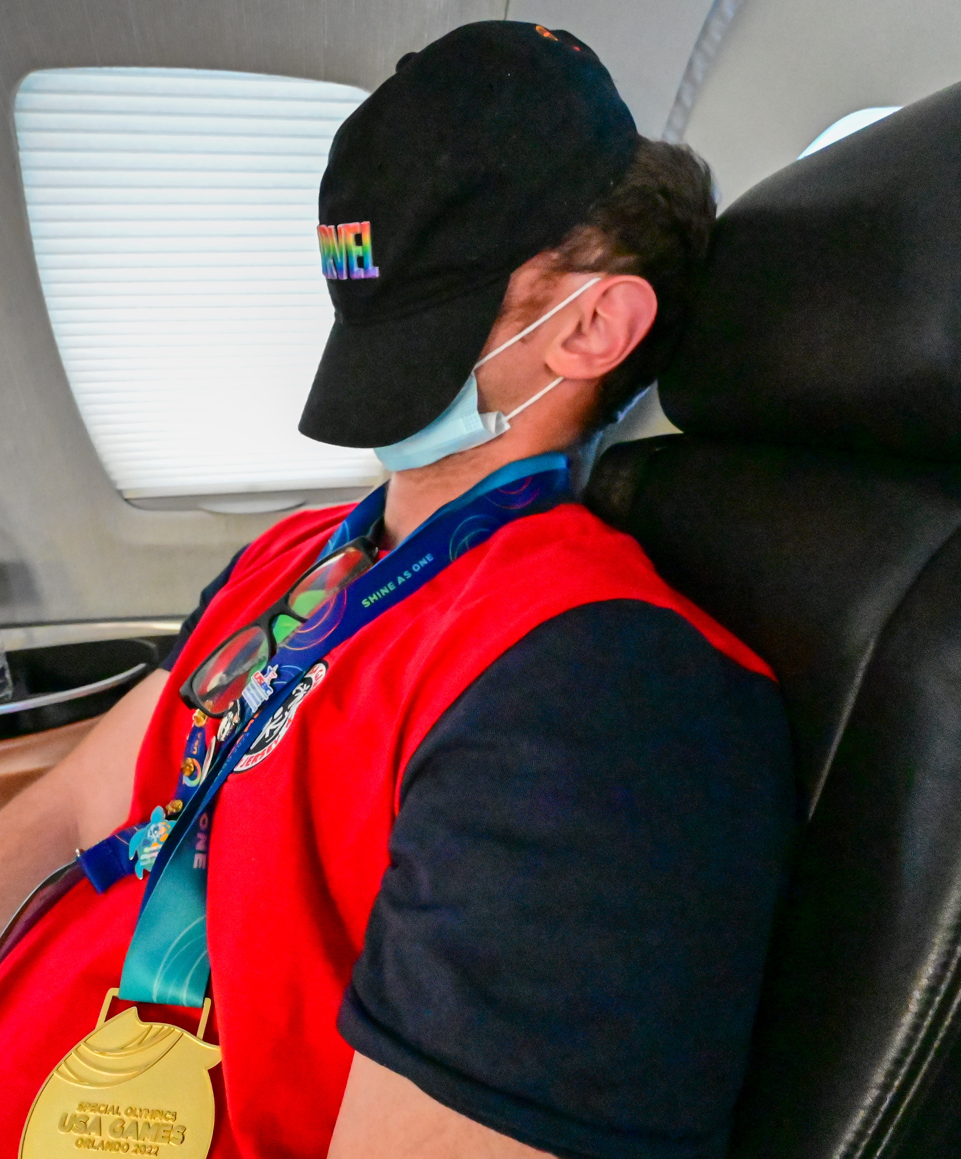 Special Olympics USA Games powerlifter Brian Beirne snoozes during the Dove 122 Special Olympics Airlift flight from Orlando, Florida, to Trenton, New Jersey. Photo by David Tulis.