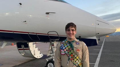 Andrew Walker smiles in front of an aircraft in his Eagle Scout uniform at Rocky Mountain Metropolitan Airport in Colorado. Photo courtesy of Andrew Walker.