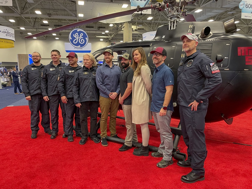 Aerobatic helicopter pilot Chuck Aaron and others from SUU Aviation and the Chuck Aaron Academy pose in front of SUU Aviation's helicopter.Photo by Cayla McLeod.