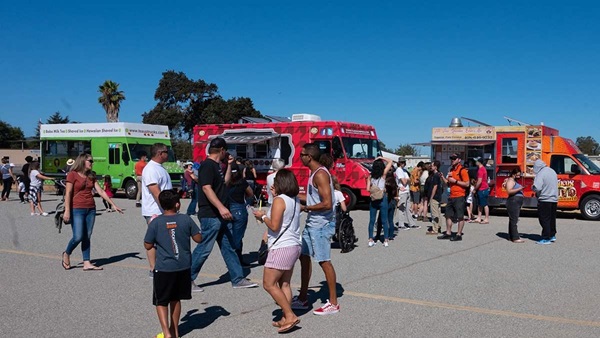 Guests of San Martin Airport's first-ever Food Truck Fly-in start to gather around the event's various food trucks. Photo by Eric Peterson.