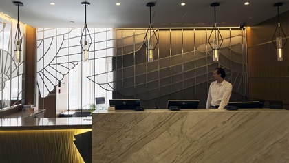 Starting with the art deco wing motifs behind the front desk, most of the lobby of the 26-story Rand Tower Hotel is aviation and industrial themed. The 1929 office building was recently converted to a Marriott Tribute Portfolio boutique hotel. Photo by MeLinda Schnyder. 