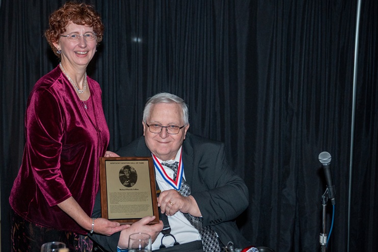 Janette Collins and Bob Minter pose with Mike Collins’ enshrinement plaque. Photo by Mark Mahan, courtesy of Aviation Museum of Kentucky Hall of Fame.