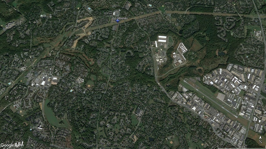 The Mooney came to rest an estimated 100 feet above the ground, hanging from power transmission lines 1 nautical mile short of the runway. Google Earth image.
