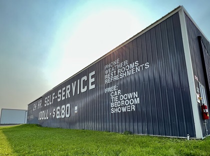 The side of the hangar advertises fuel prices and amenities available at Mustang Mickey’s at Helena Regional Airport. Photo by Erick Webb.