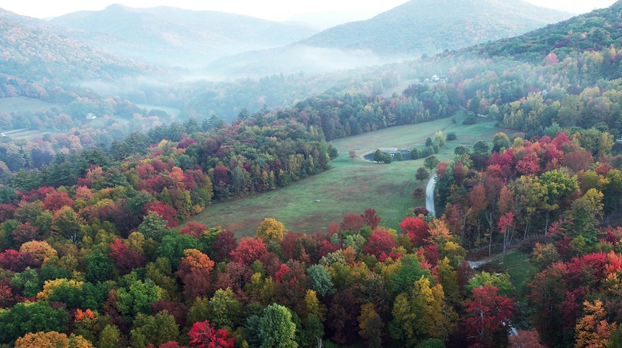 Mist blanketed the Taconic Mountains in Arlington, Vermont, in late September 2020. The color this year is expected to peak around the same time: starting in late September to the north, and early October here. Photo by Jim Moore.