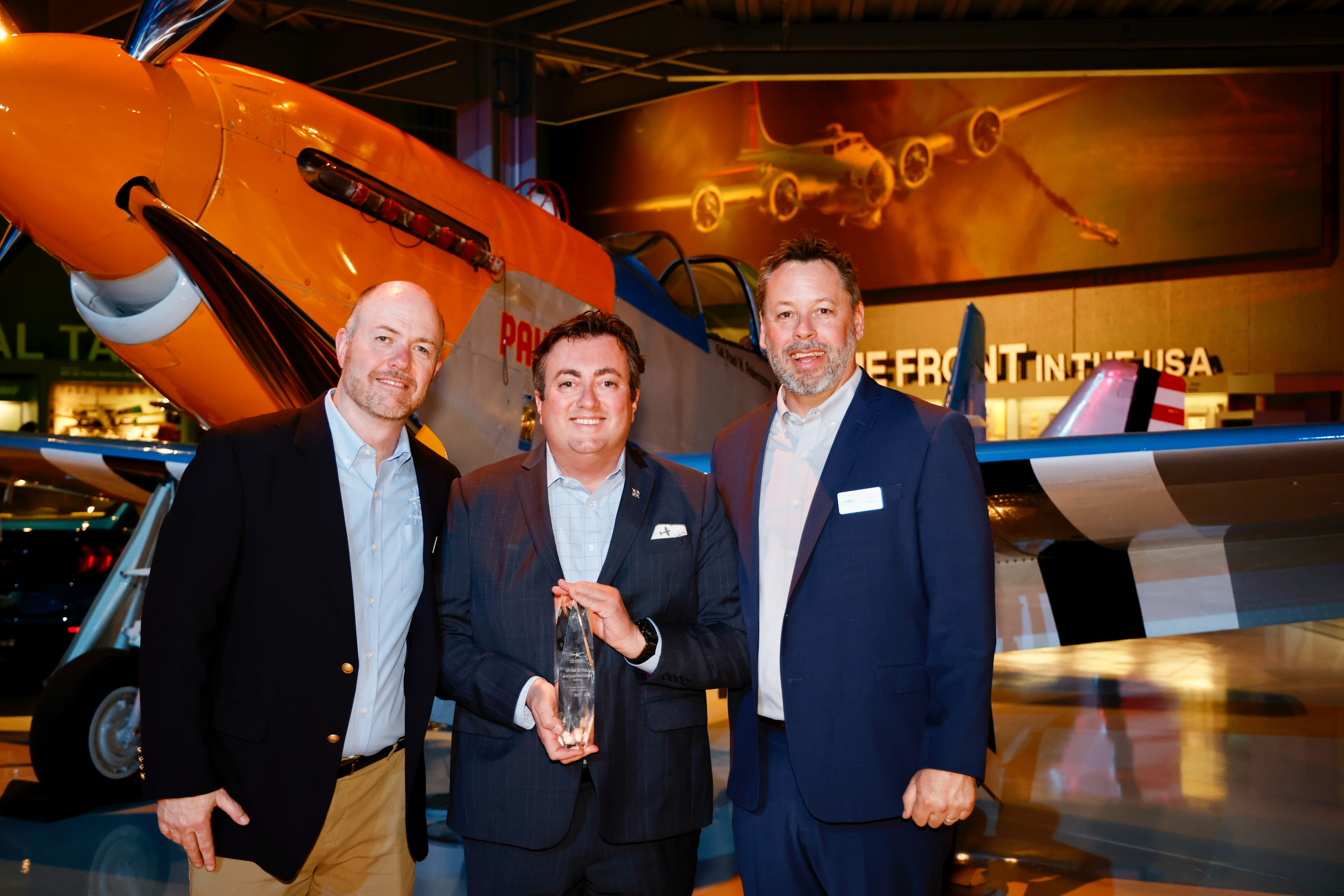 AOPA’s Dan Justman and Chris Moser celebrate with Bryan Gutraj, winner of the national best flight instructor award from the AOPA Flight Training Experience Survey. Photo by Chris Rose.