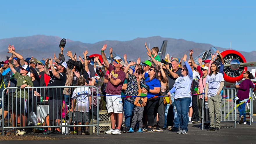Air show attendees acknowledge performers at the Buckeye Air Fair in Buckeye, Arizona, near Phoenix, February 18, 2023. Photo by David Tulis.