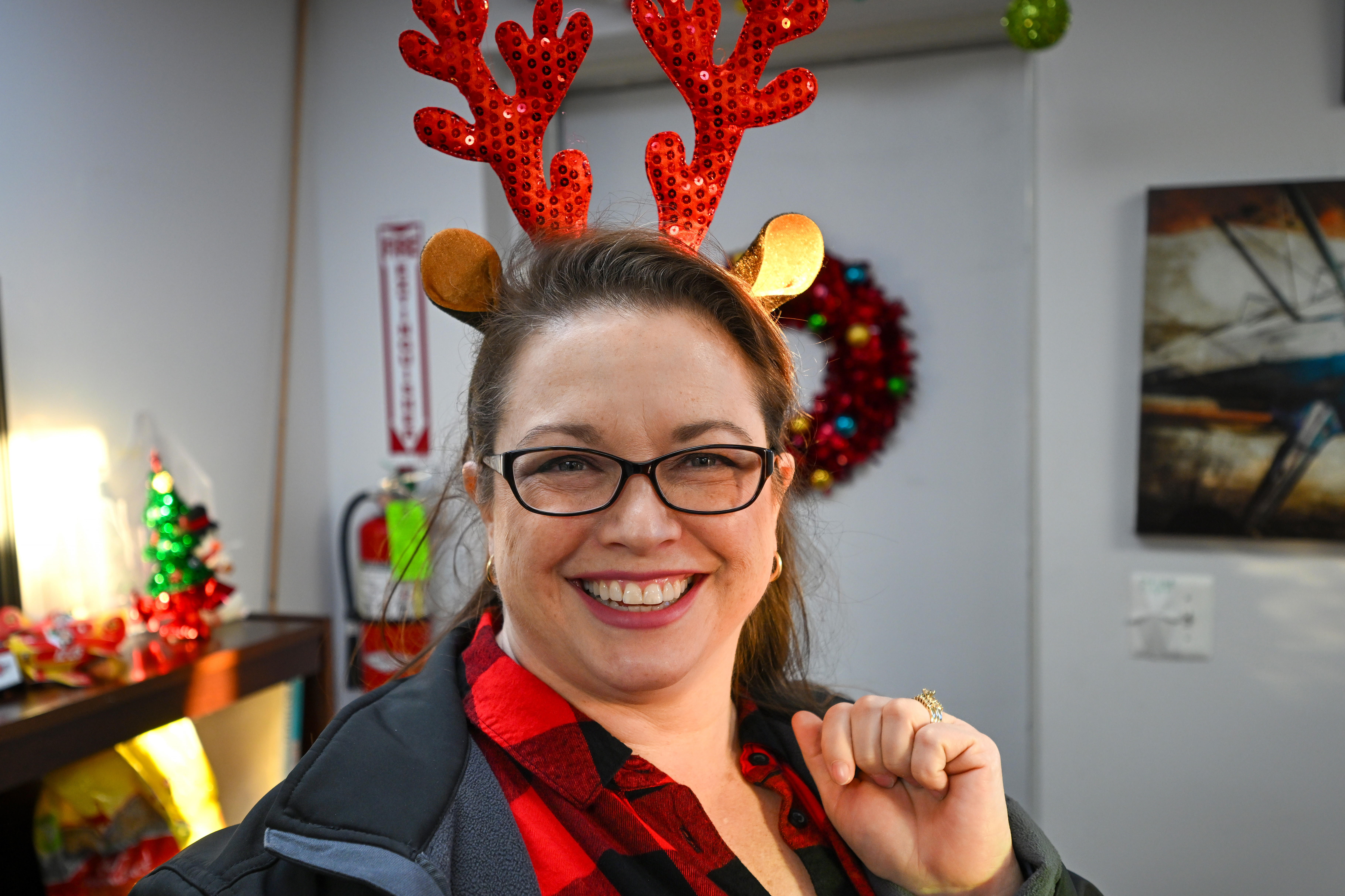 AOPA Pilot Information Center Medical Certification Specialist Anita Fetzer gets into the holiday spirit at Bay Bridge Airport in Stevensville, Maryland, before helping deliver holly branches, school supplies, and holiday presents to 400 residents of Tangier Island, Virginia. Photo by David Tulis.