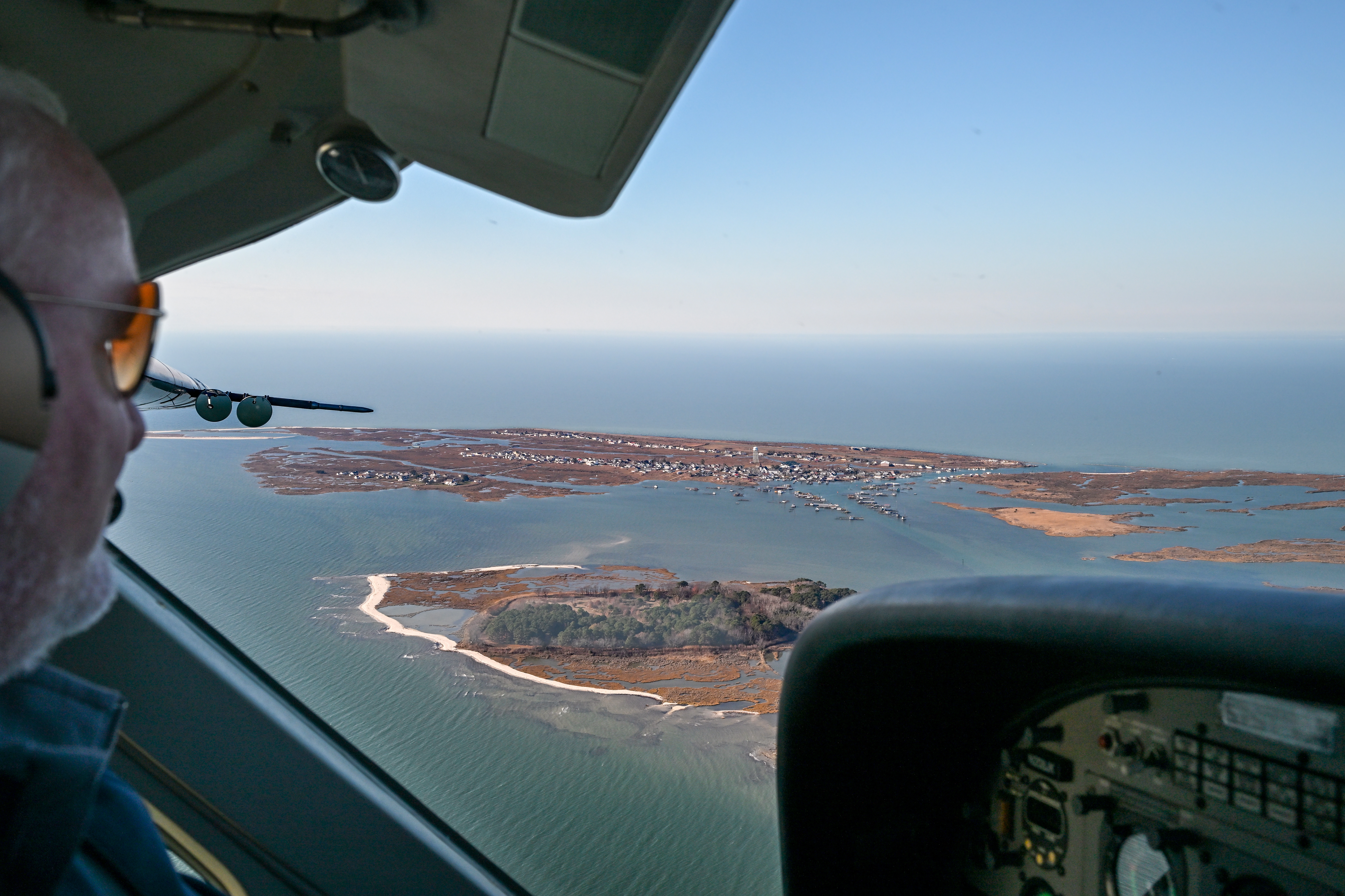 AOPA President Mark Baker on approach to Tangier Island in a Cessna 208 Caravan bringing fresh holiday greenery, school supplies, and other necessities to the fishing village in the Chesapeake Bay. Photo by David Tulis.