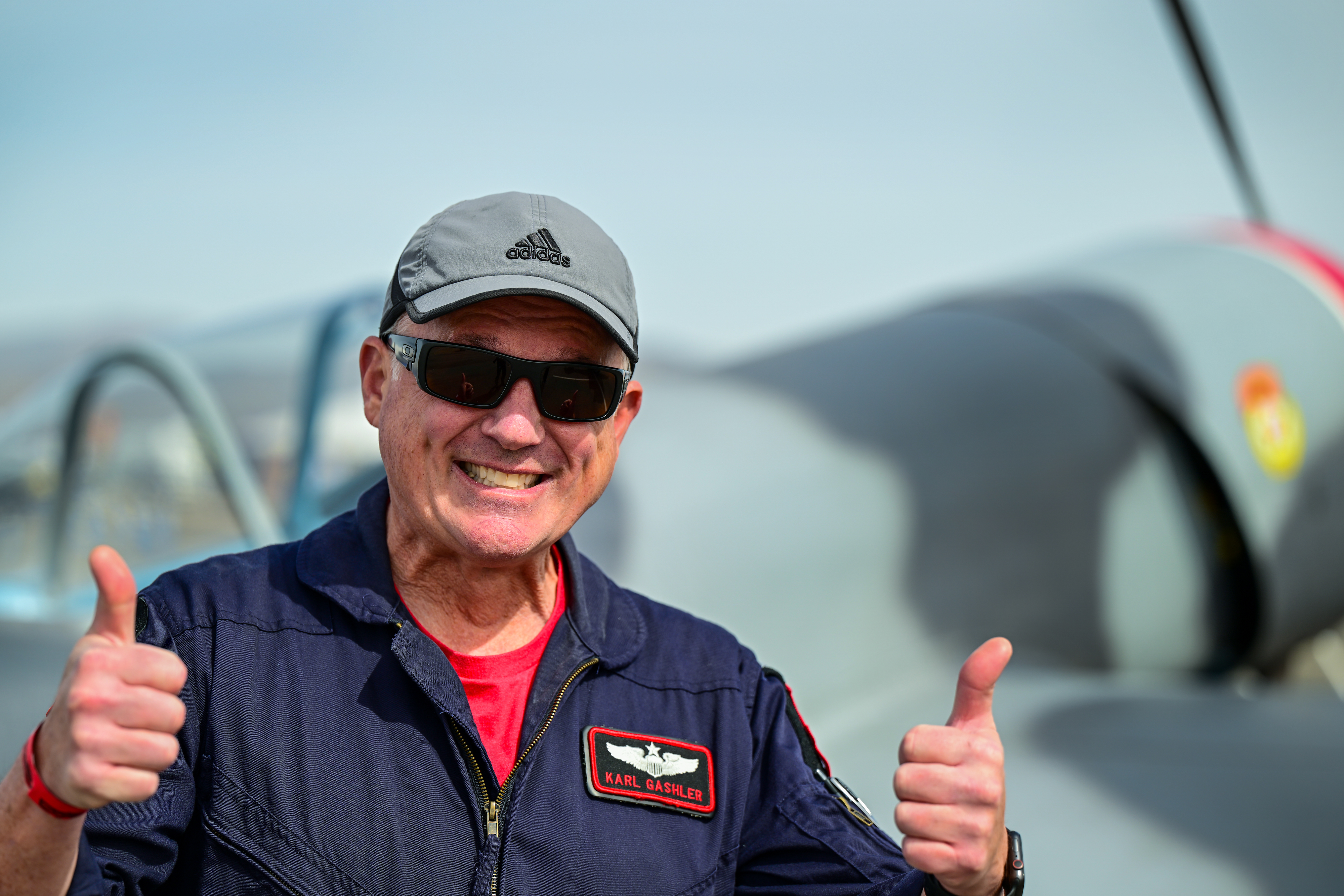 Local airshow pilot Karl Gashler gestures near his Yak 50 aircraft during the Buckeye Air Fair. Photo by David Tulis.