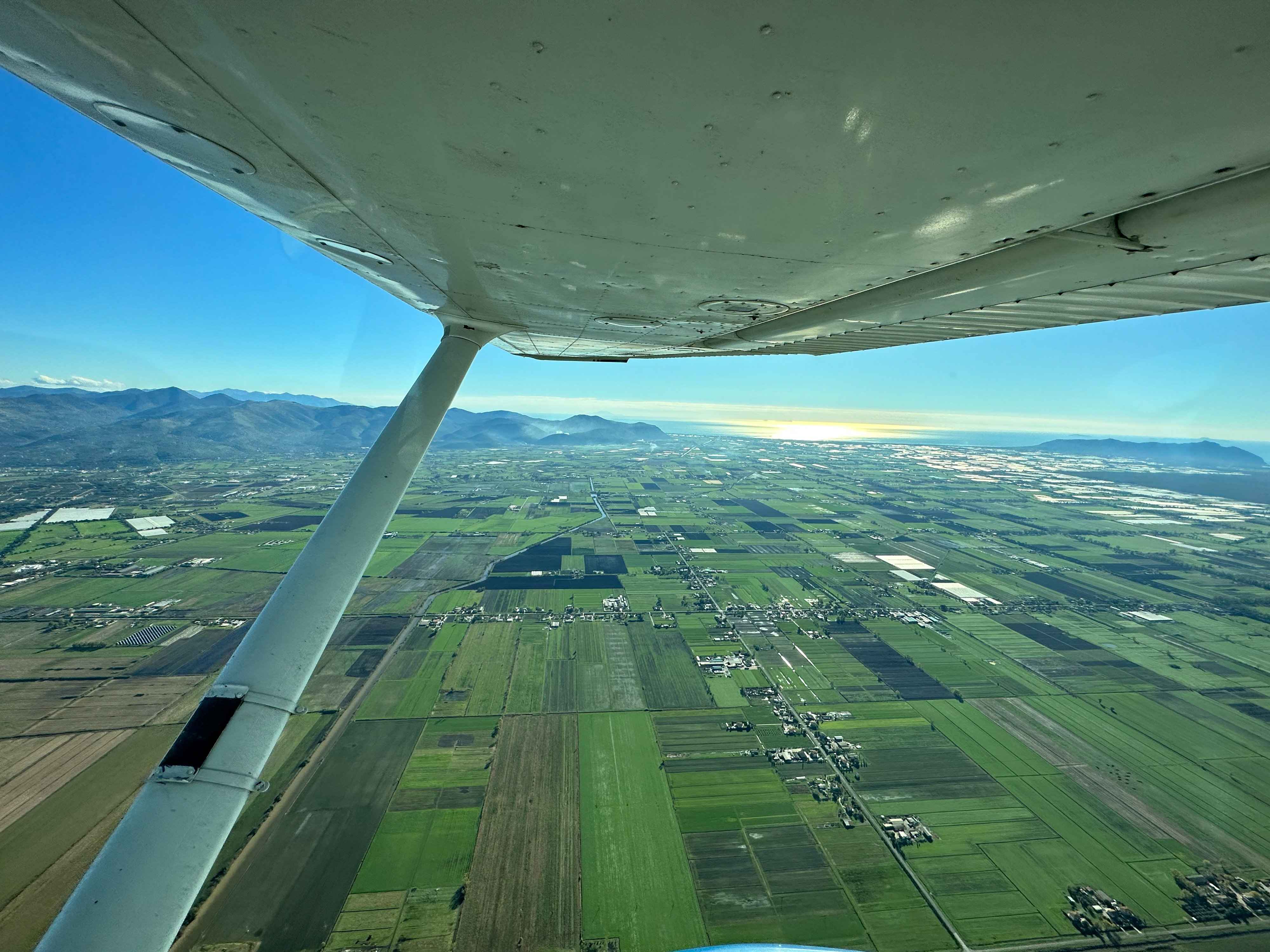 The Pontine Plain, or Pontine Marshes, from about 2,000 feet. The plain is a 180-square-mile area in the Lazio region of west central Italy reclaimed and developed as a thriving agricultural area. Photo by Mary Michael.