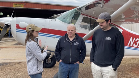 AOPA Social Media Marketer Cayla McLeod Hunt, Dave Stoots, and Parker Thaxton discuss the next steps for the AOPA Sweepstakes Cessna 170B after the successful flight. Photo by Jack Reynolds.