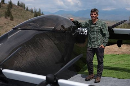 Tim Lum stands with his BlackFly light eVTOL. Photo courtesy of Opener.