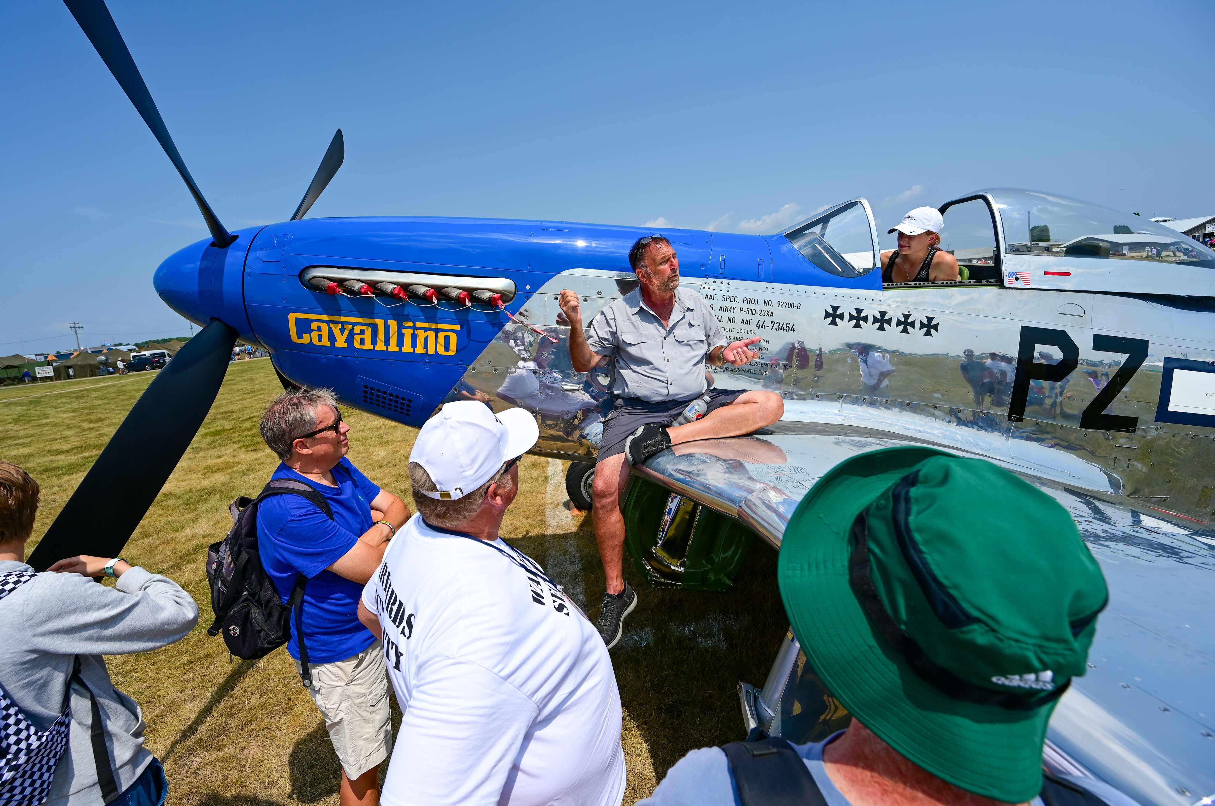 North American P-51D Mustang pilot Darren Bond enlightens a crowd in the warbird area to help introduce the classic World War II fighter to others during EAA AirVenture Oshkosh. Photo by David Tulis.
