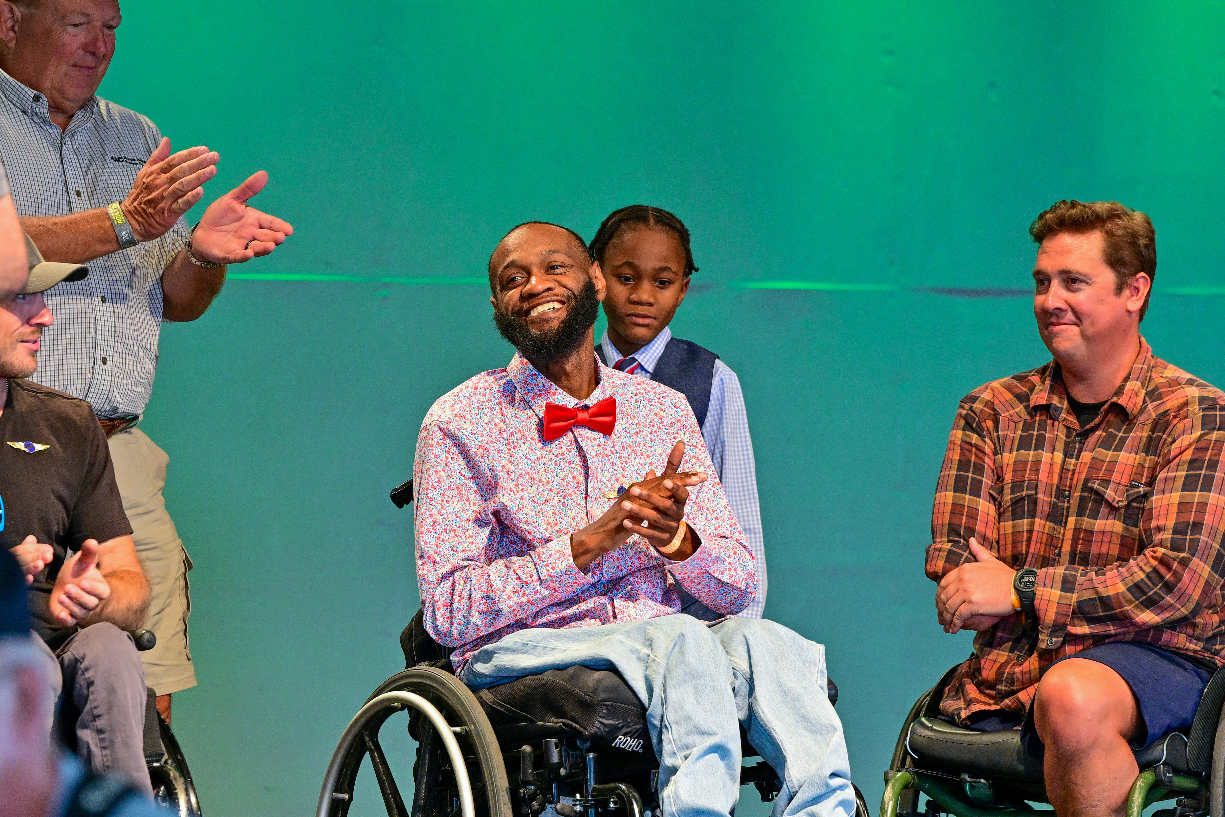 Able Flight class of 2023 scholarship winner Dijon McCorkle applauds as Robert 'Bobby' Dove looks on during their pinning ceremony. Photo by David Tulis.
