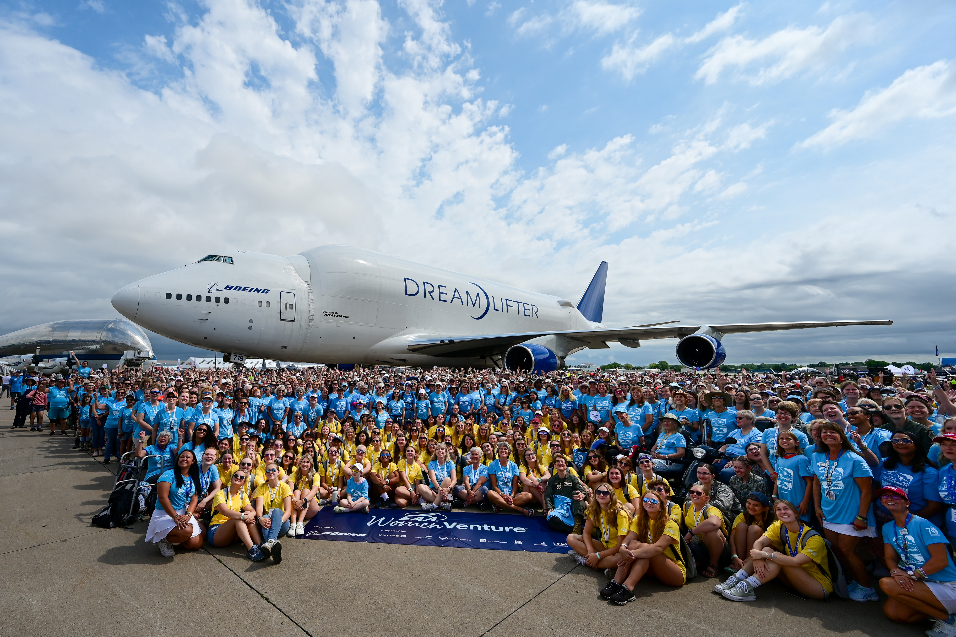 WomenVenture participants gather for a group photo near a Boeing Dreamlifter and NASA's Super Guppy. Photo by David Tulis.