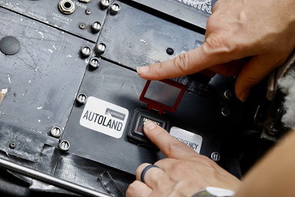 A guarded switch prevents inadvertent activation of the emergency aircraft automation. Photo by Chris Rose.