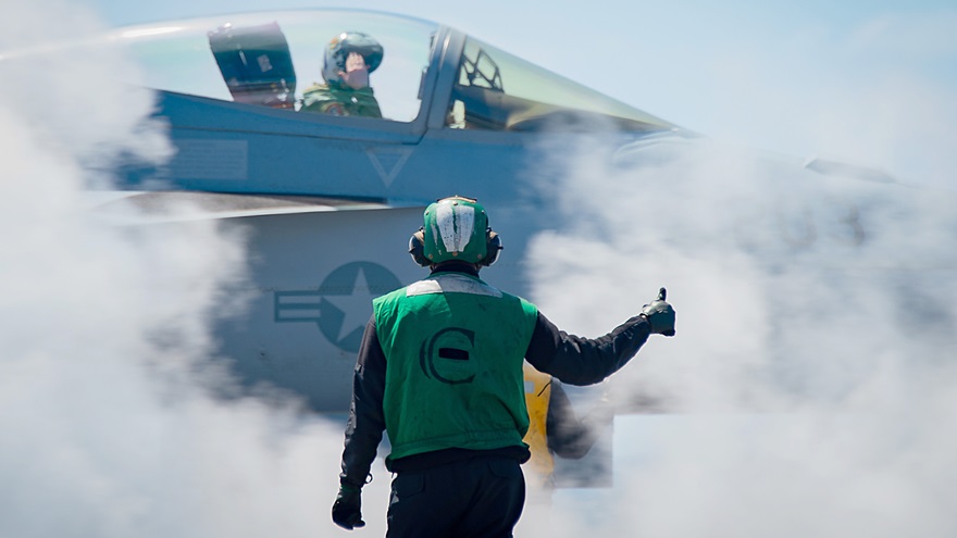A sailor signals the pilot of a Boeing F/A-18E Super Hornet before it launches off the 'USS Carl Vinson.' The FAA is offering military veterans caught up in an investigation of pilot medical certificate applications an opportunity to reconcile their record. U.S. Navy photo by Mass Communication Specialist 3rd Class Leon Vonguyen.