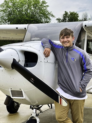 Student Ebert White poses next to AlphaFlight’s Cessna 172 after his first solo flight. Photo courtesy of AlphaFlight. 