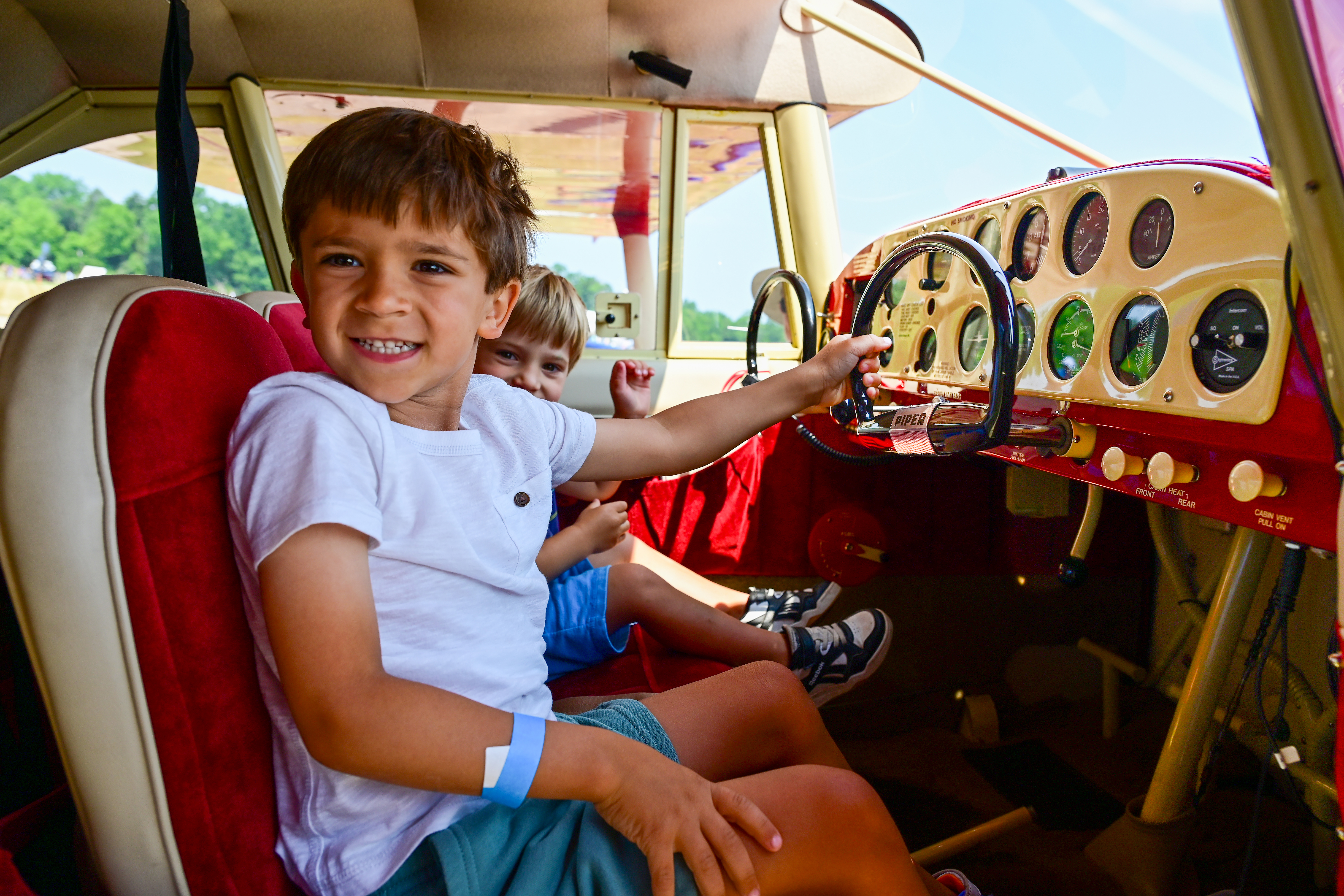 Youth try out the controls of a restored 1953 Piper Tri-Pacer parked at the Smithsonian National Air and Space Museum's Steven F. Udvar-Hazy Center during Innovation in Flight Day June 17. Photo by David Tulis.