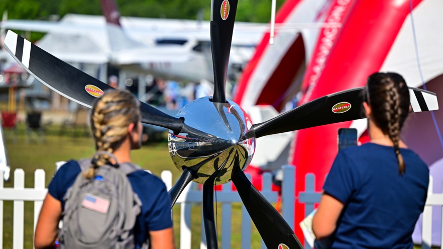 A composite Hartzell five-blade propeller designed for a TBM 100 captures the attention of Casey Gabelli and Katie Tyriver after its introduction during the Sun 'n Fun Aerospace Expo in Lakeland, Florida, March 28. Photo by David Tulis.