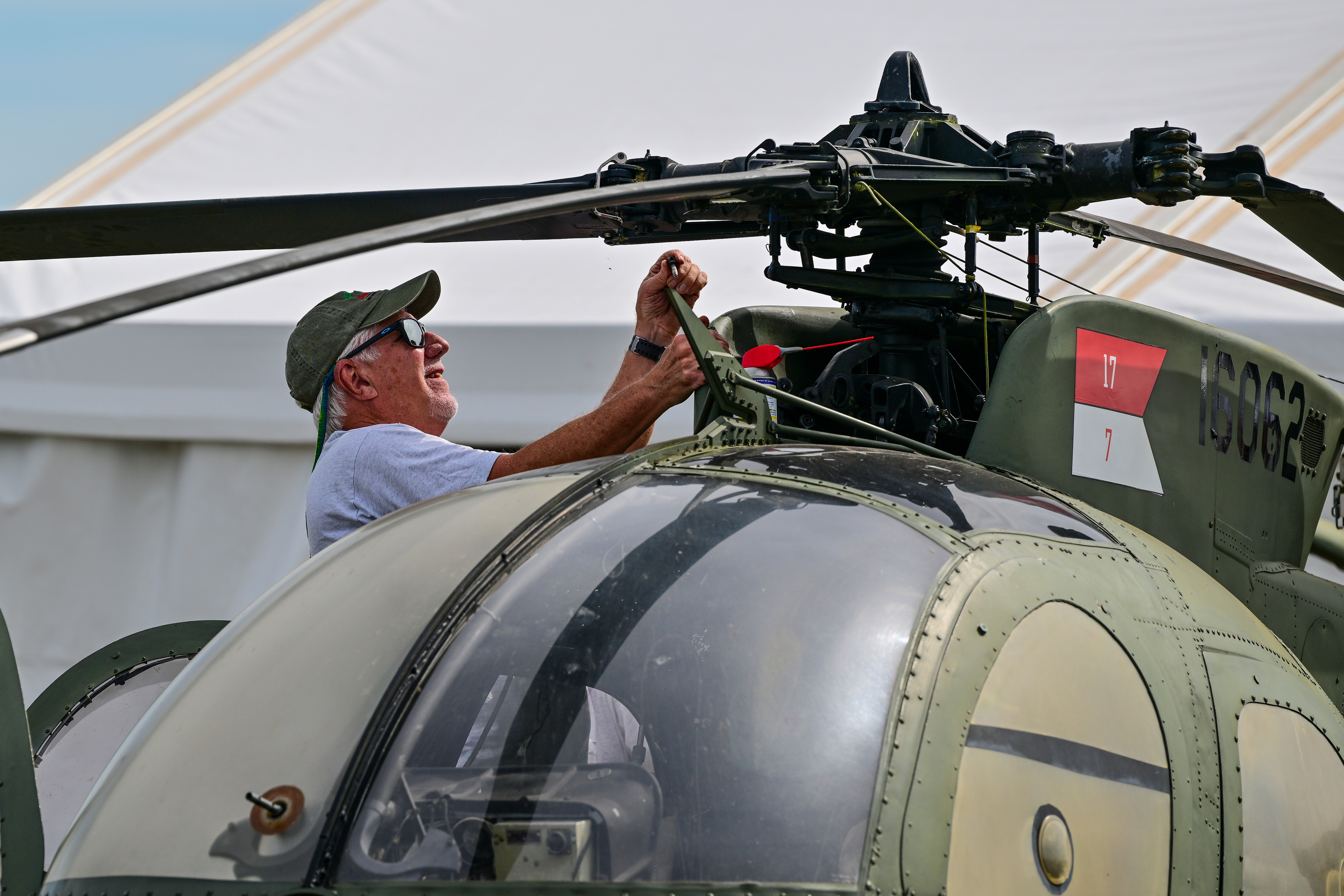 A Hughes OH-6A helicopter is readied for display. Photo by David Tulis.