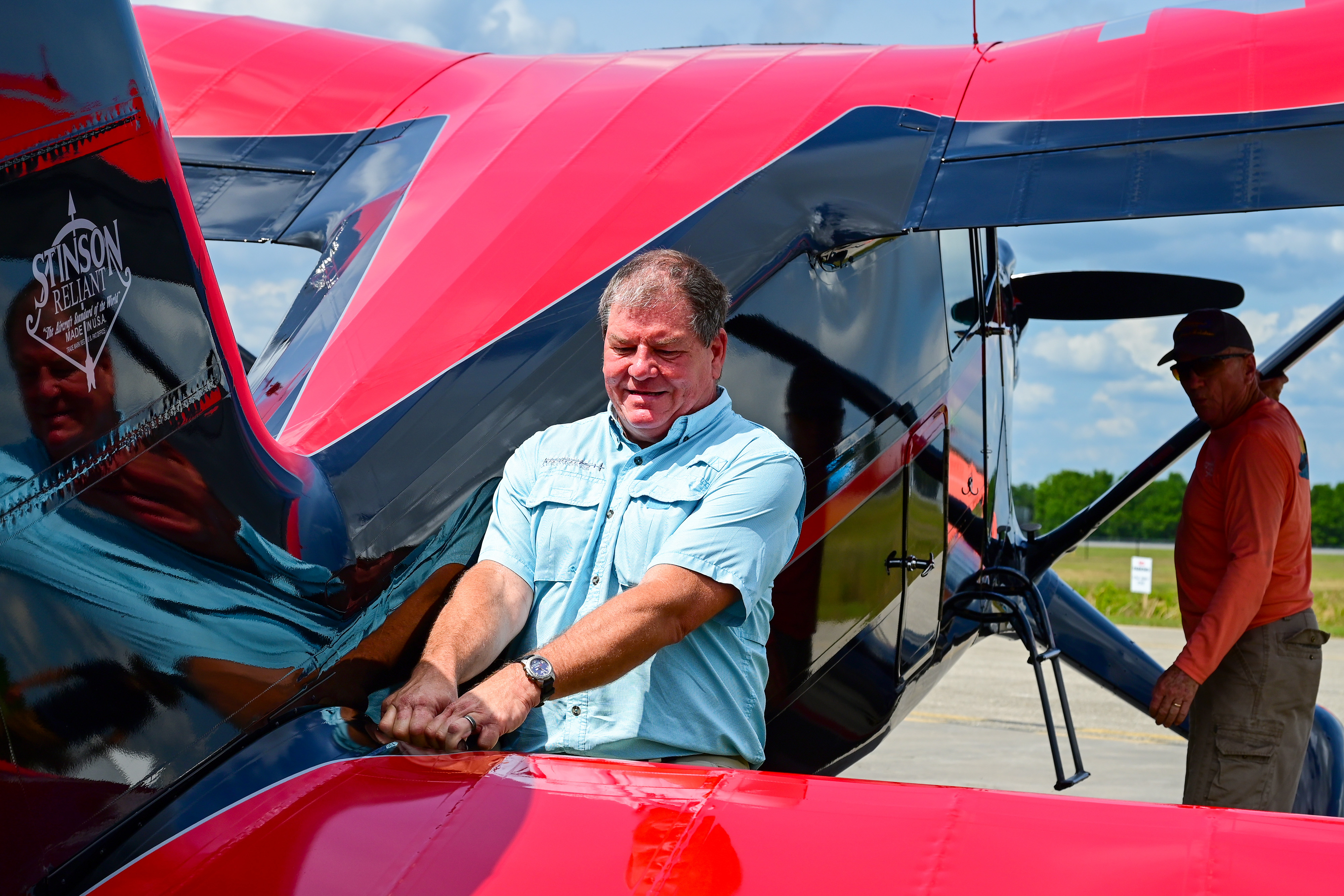 Brian Norris of Spruce Creek, Florida, wrangles a Stinson Reliant into a display space. Photo by David Tulis.
