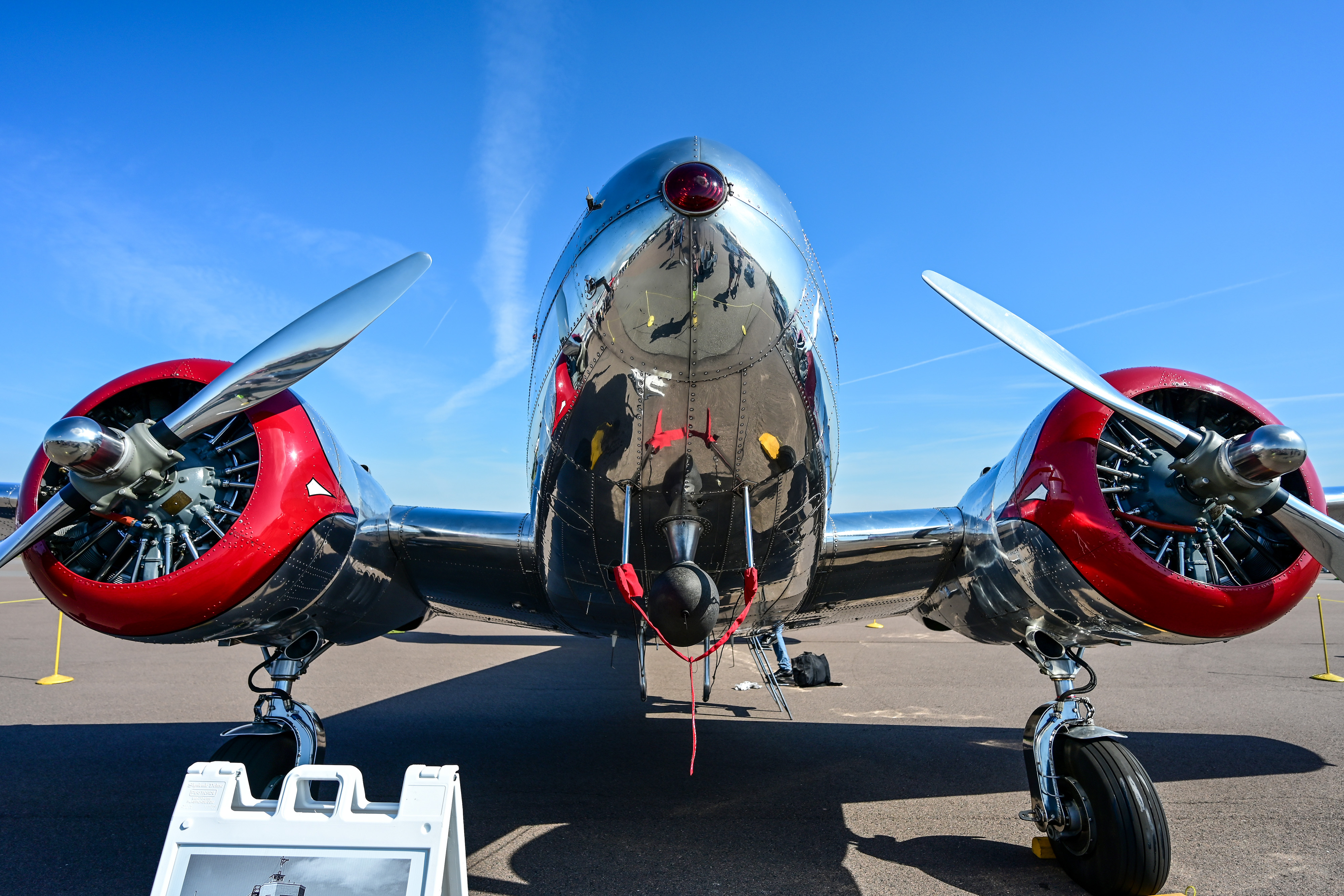 A Lockheed Model 12A Electra Junior reflects the warbird ramp surroundings. Photo by David Tulis.