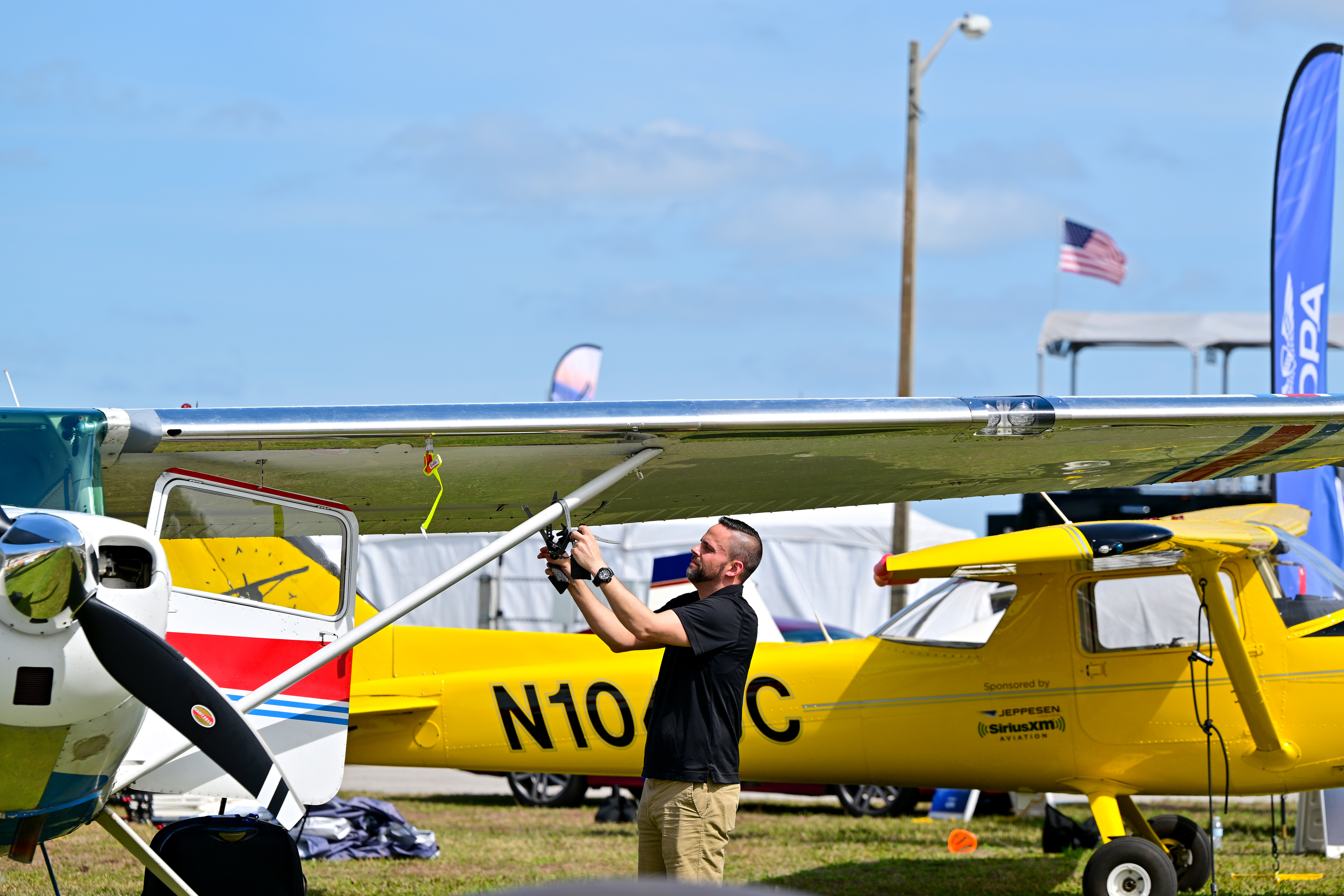 AOPA Social Media Marketer Erick Webb removes a video camera that helped document the two-day journey to Florida in the AOPA Sweepstakes Cessna 170B for the Sun 'n Fun Aerospace Expo. Photo by David Tulis.