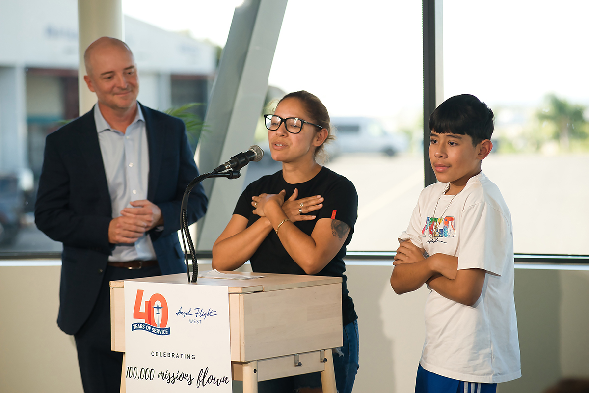 Luis Peña and his mother Maria Pérez express gratitude for Angel Flight West with Executive Director Josh Olson, during a press conference. Photo courtesy of McCall Jones/American Aviation News.