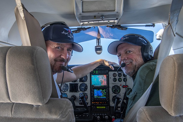 Edward Norton and Michael Langston smile for a photo on the second leg of Angel Flight West’s 100,000th mission. Photo by Niki Britton.
