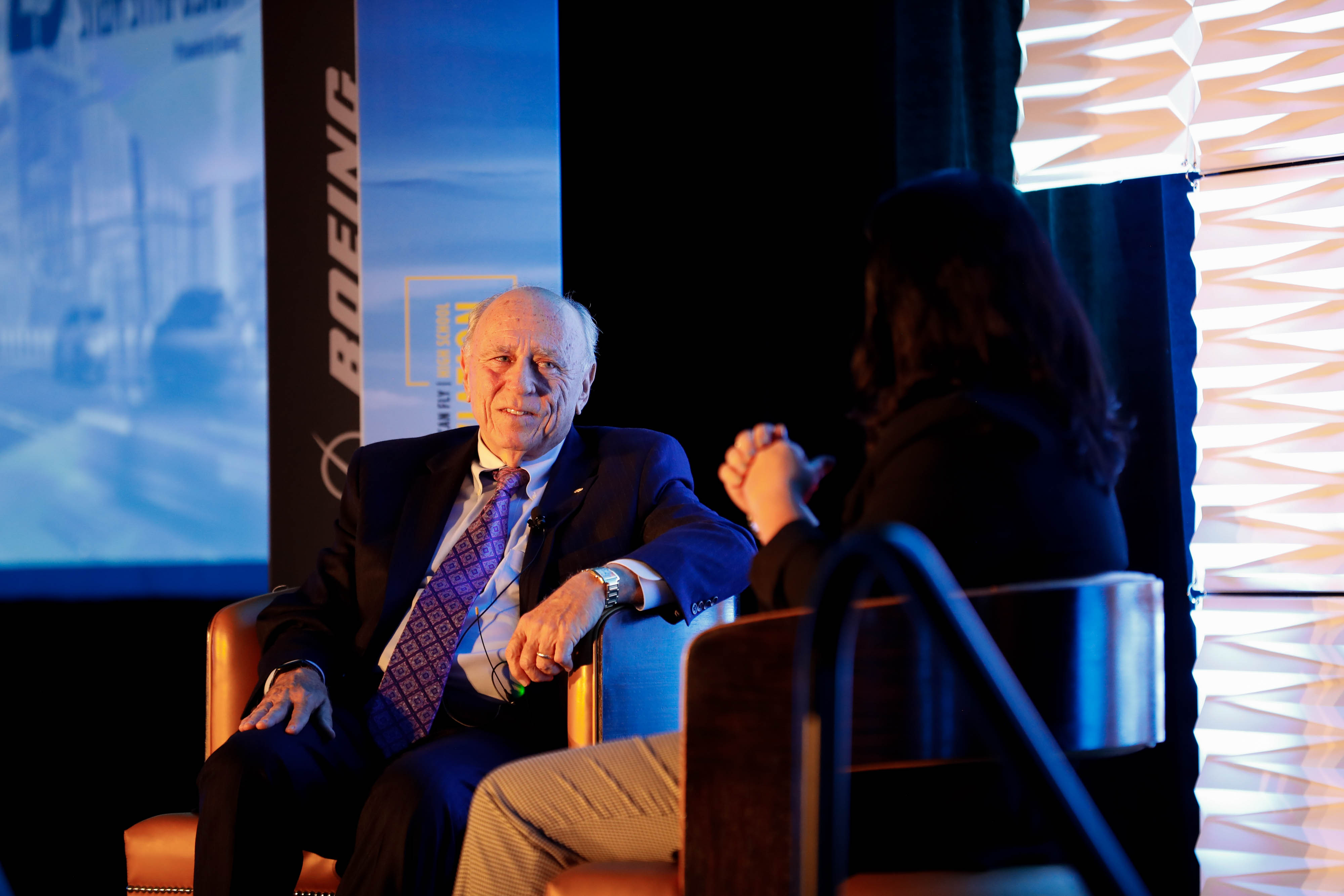 Jeff Fuqua, past chairman of the Greater Orlando Aviation Authority, speaks with AOPA Chief Operating Officer Elizabeth Tennyson during the symposium opening general session. Photo by Rebecca Boone.