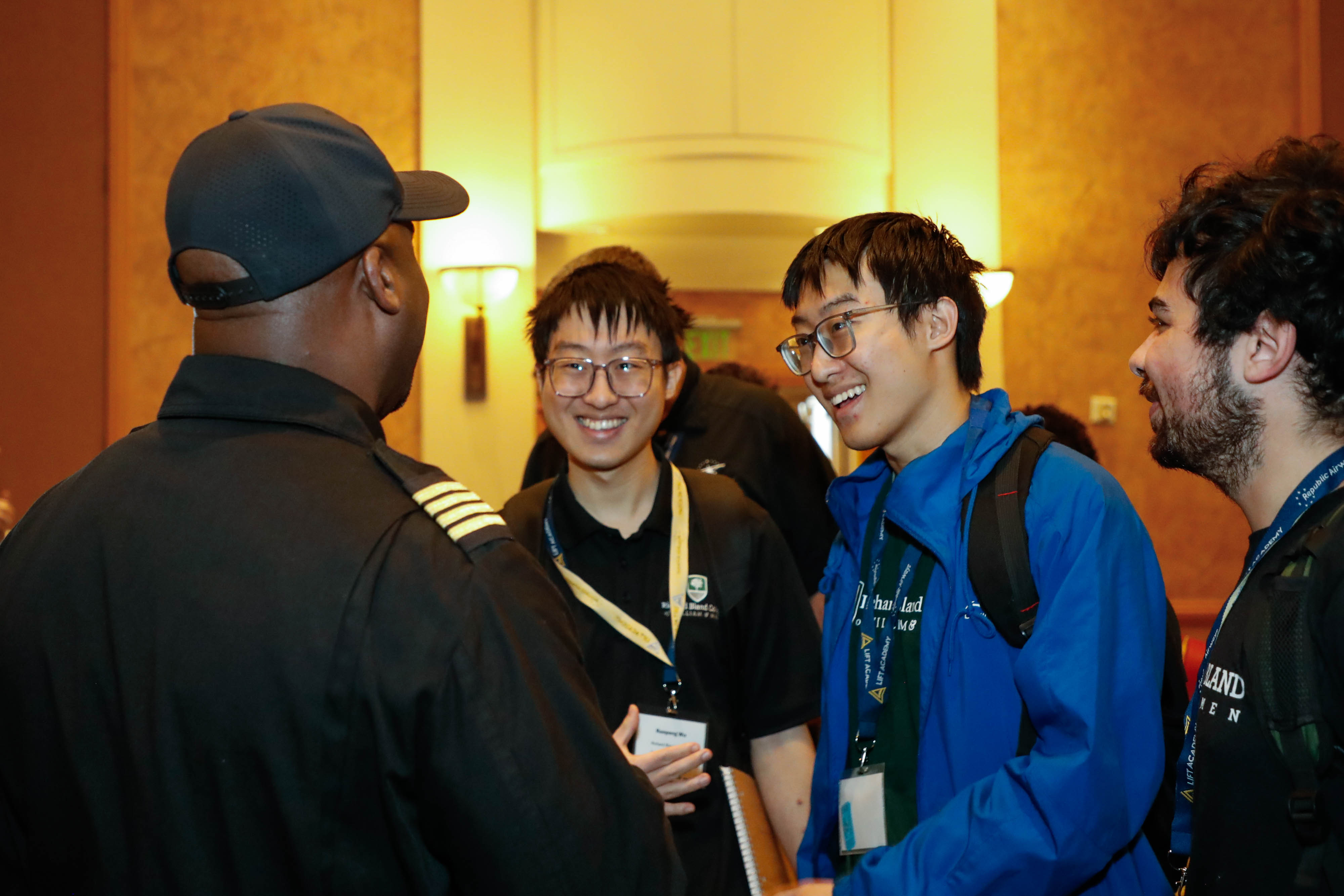 Barrington Irving chats with Ruopeng Wu (left), Ruokun Wu (middle), and Aykhan Bayramov (right) from Richard Bland College in South Prince George, Virginia. Photo by Rebecca Boone.