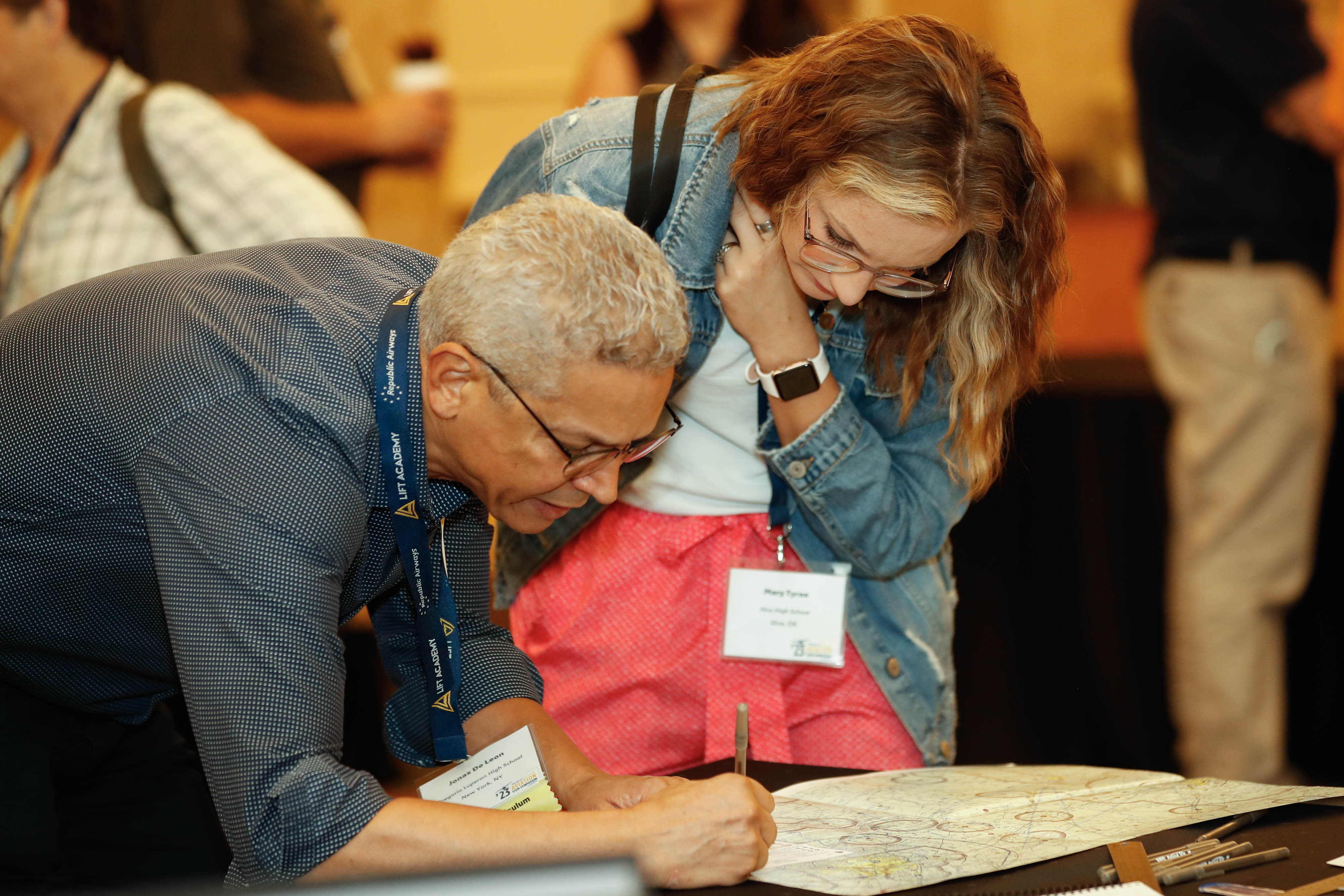 Jonas De Leon from Gregorio Luperon High School in New York City and Mary Tyree from Alva High School in Alva, Oklahoma, review a chart during a hands-on workshop. Photo by Rebecca Boone.