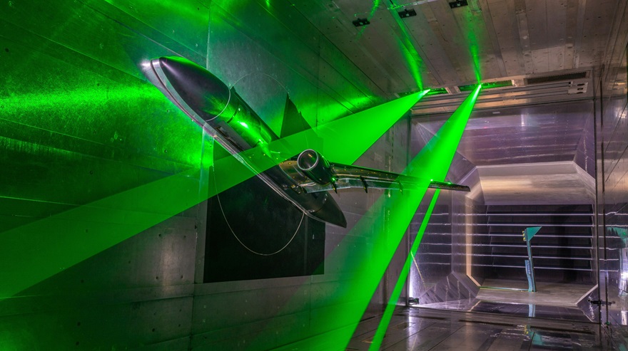 A NASA aircraft model is tested in collaboration with the German Aerospace Center (DLR) in the Braunschweig Low-Speed Wind Tunnel in Germany. Lasers measure the airflow over the wing. Photo courtesy of DLR.