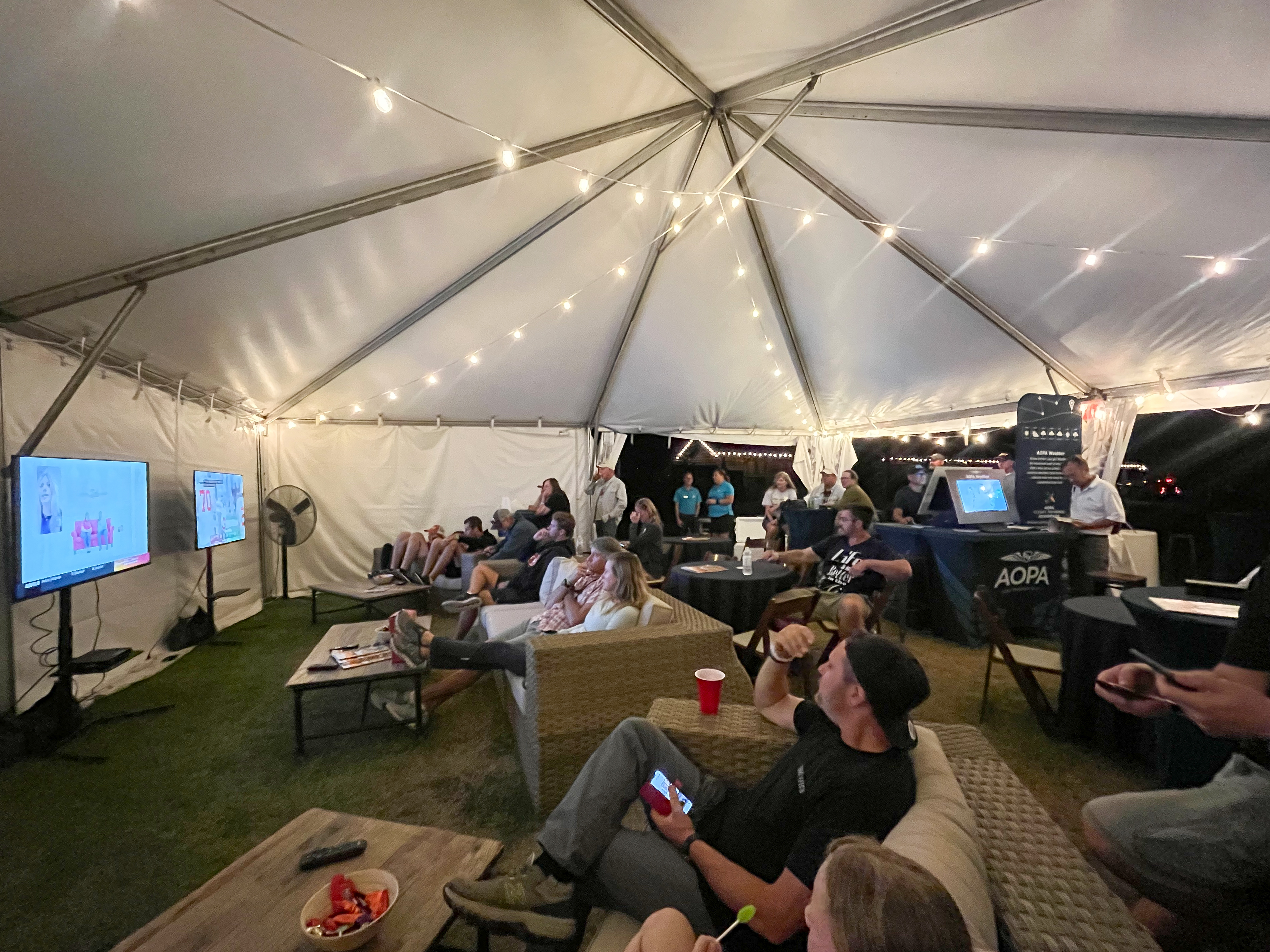 The AOPA Oasis hospitality tent at the Triple Tree Fly-In provided a shaded area for attendees to watch college football, connect with free Wi-Fi, and use AOPA Weather and iFlightPlanner for AOPA on dedicated computer stations. Photo by Kim Trischman.