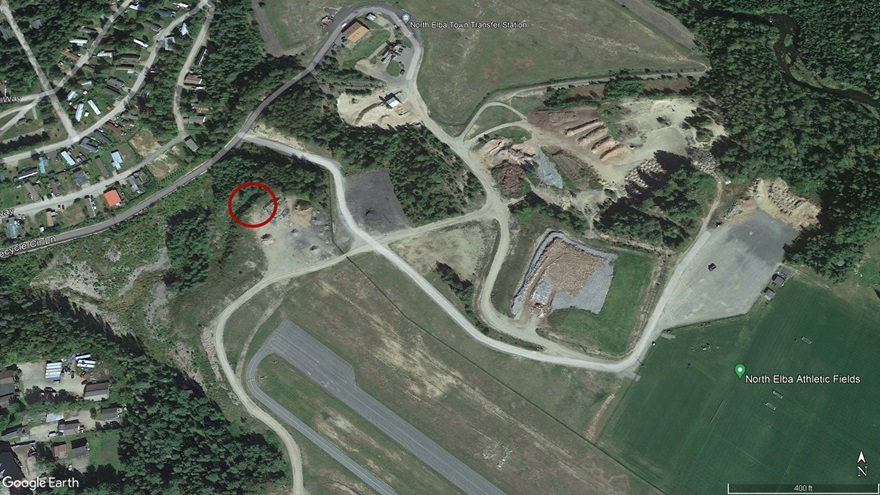 This satellite view shows Runway 14 at Lake Placid Airport, with the location where the Cessna 177RG impacted terrain 440 feet from the approach end circled in red. Google Earth image.