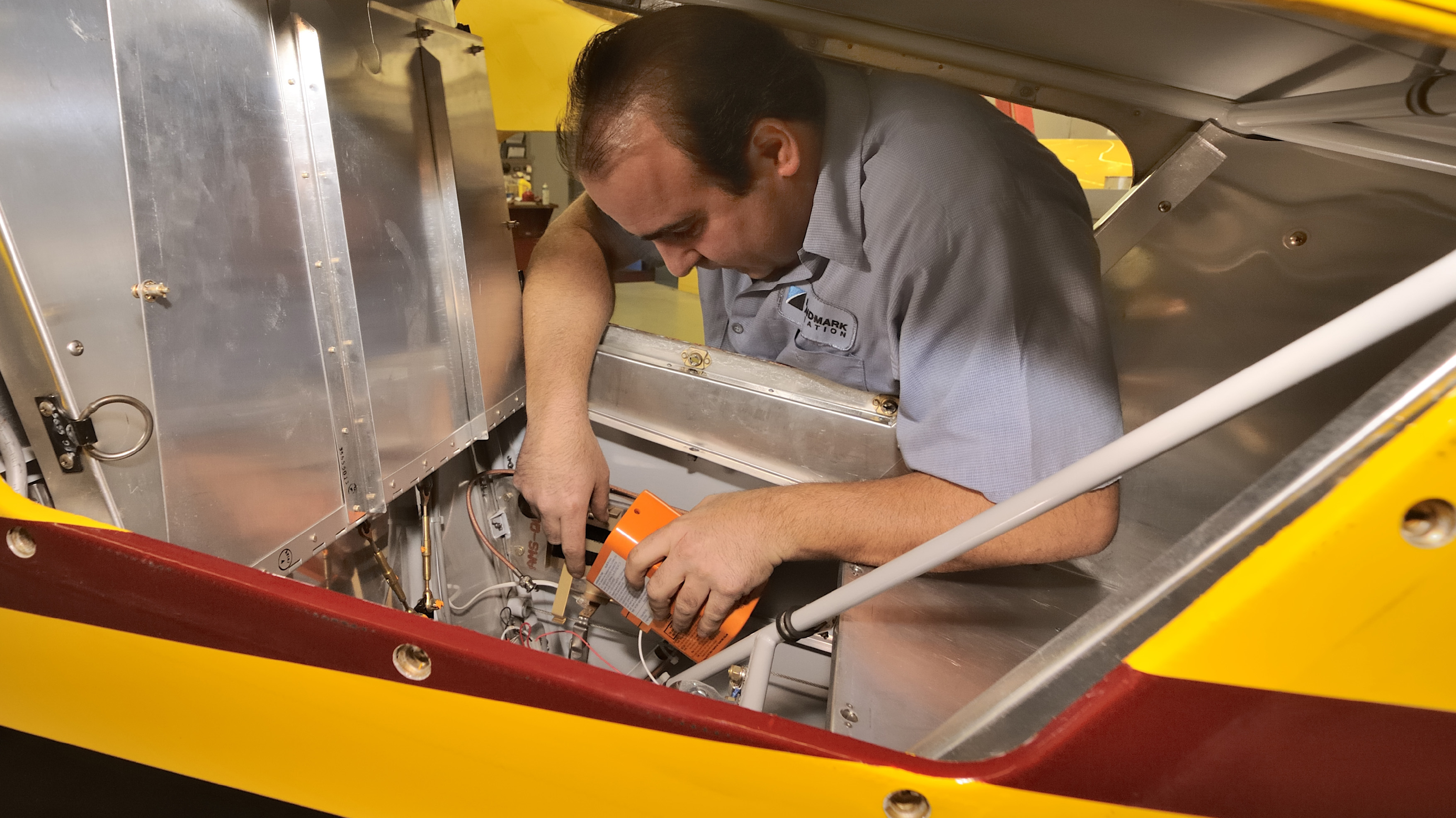 An emergency locator transmitter is removed for service during an annual inspection. Photo by Mike Collins.