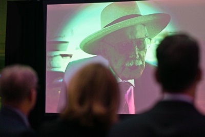 Attendees watch an archived video presentation by aviation legend R.A. 'Bob' Hoover during the eighth annual awards reception. Photo by David Tulis.