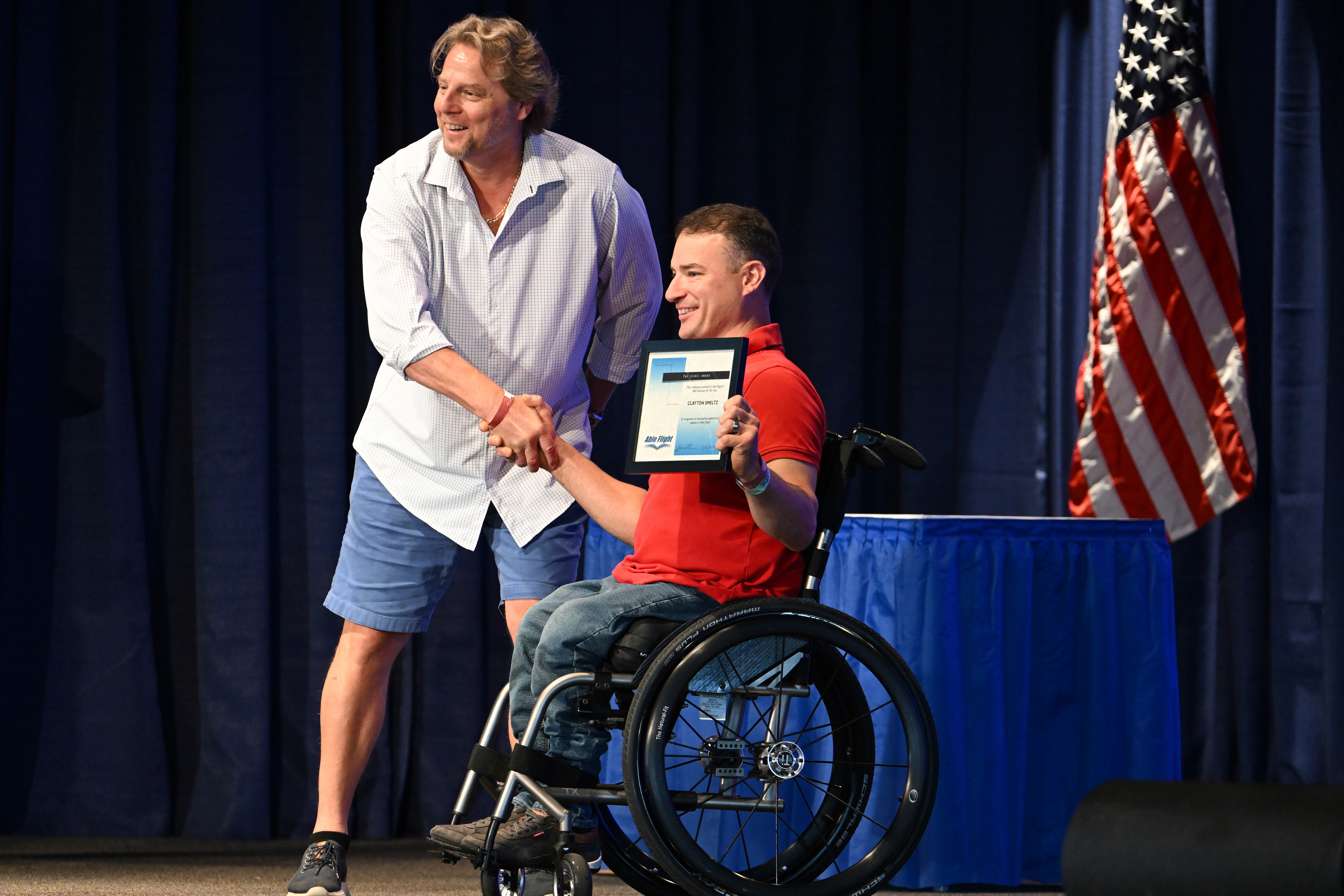 Able Flight pilot Clayton Smeltz is recognized by William Perrone. Photo by David Tulis.